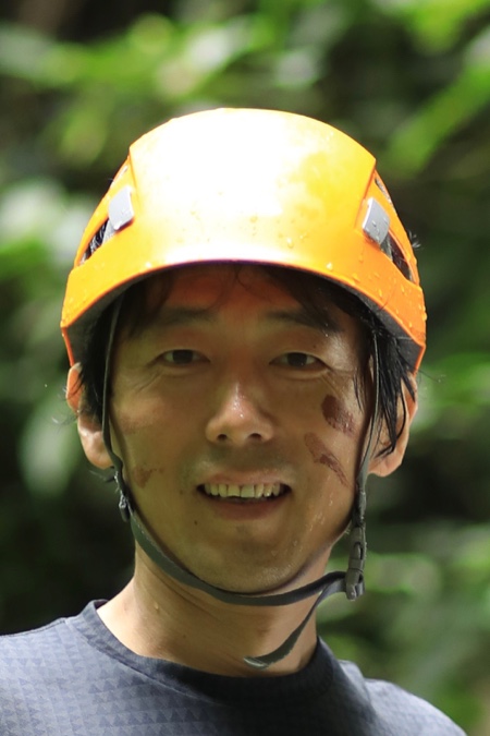 Tao, founder of Musquared, smiling outdoors in an orange helmet